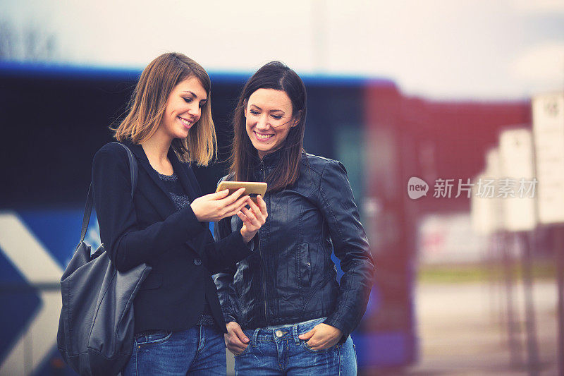 Young women waiting on the bus station